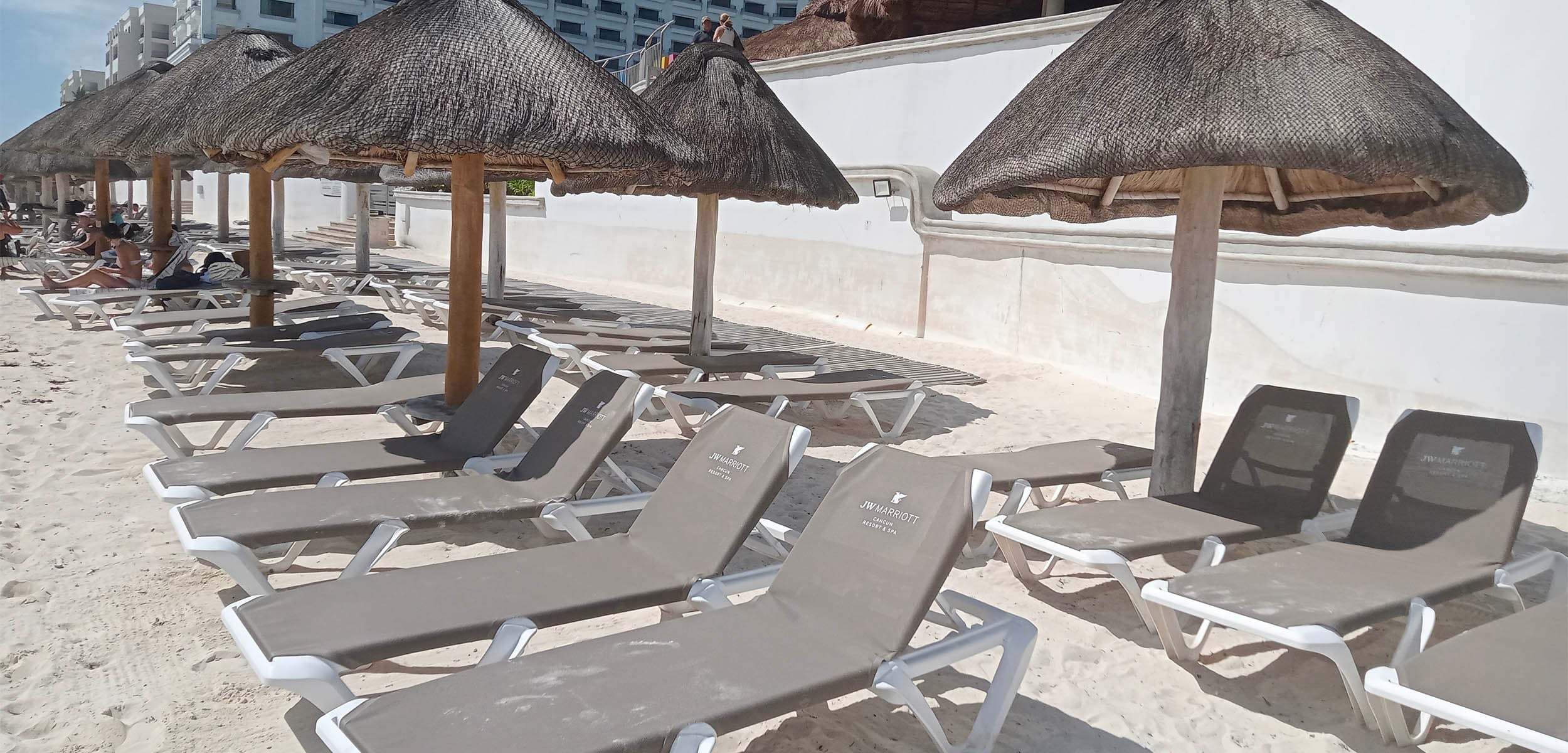 custom logo chaise lounges on the beach in Cancun