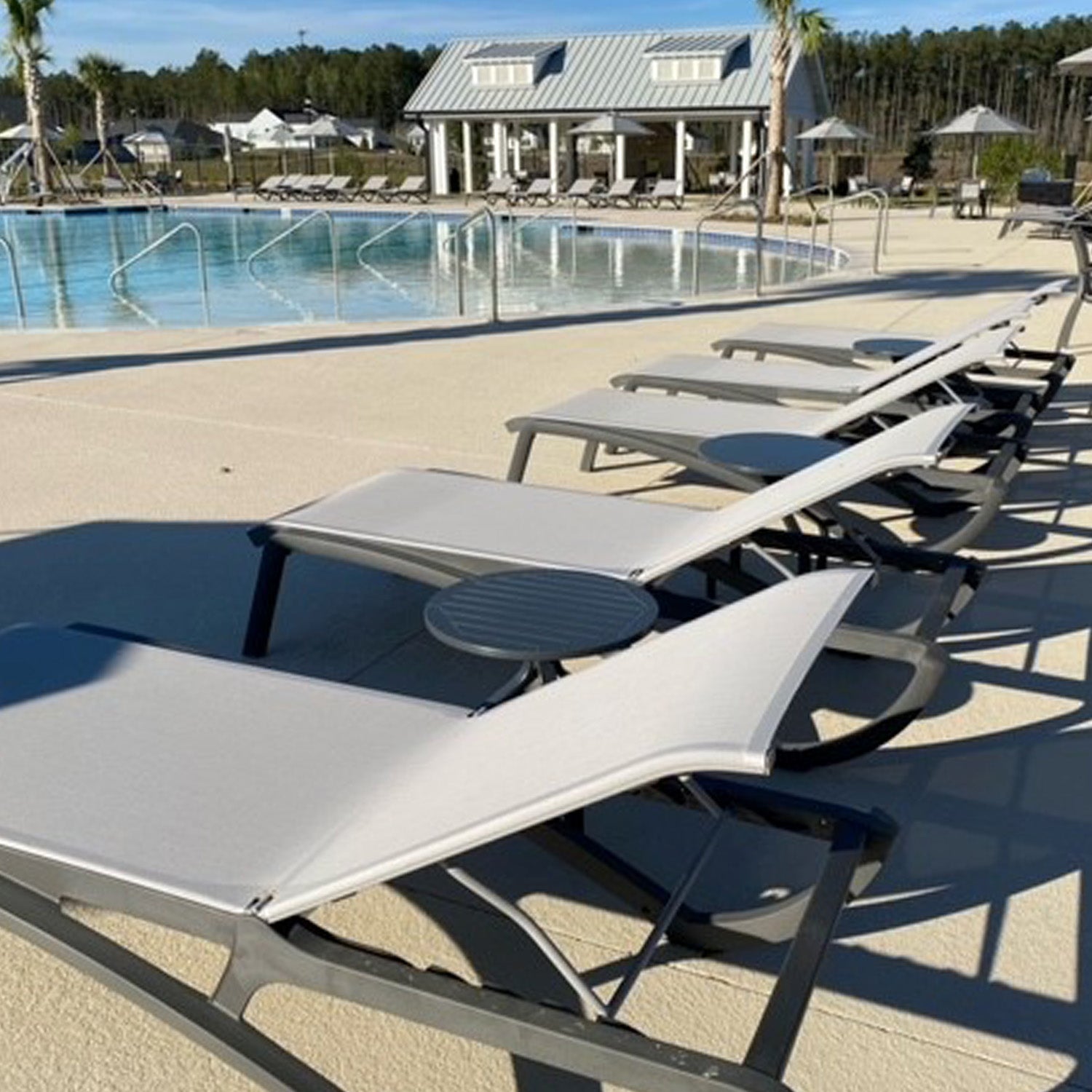 Sunset Chaise Lounges in a row by the pool at Watson Hill HOA