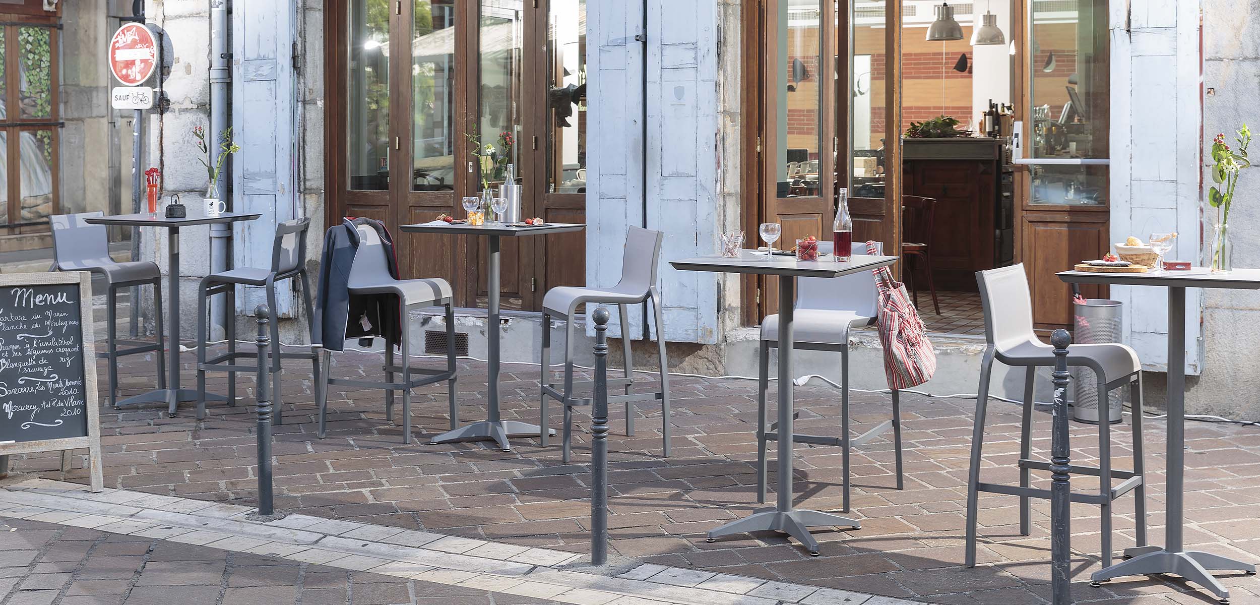 Bar Height Tables and Armless Barstools on a patio